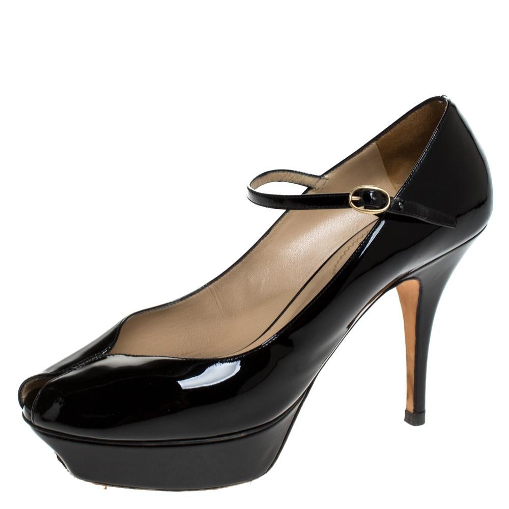 Own the city with this pair of fabulous pumps from Saint Laurent Paris, crafted from black patent leather with a classic look. Part of the Tribute collection, these mary janes are designed with self-covered platforms and 10.5cm heels, designed with
