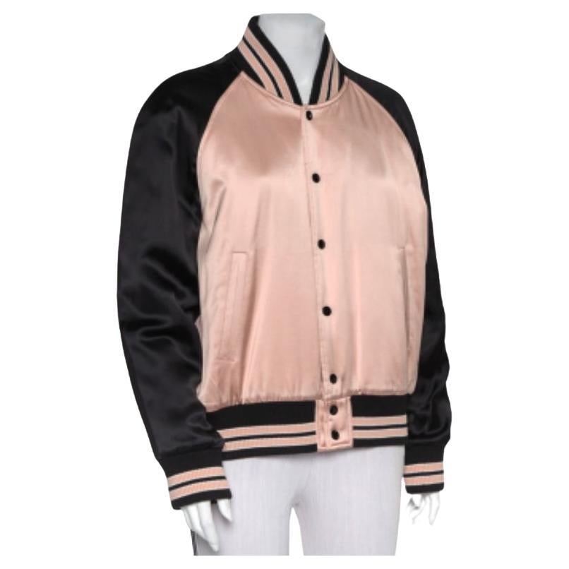 Complete a luxe look by wearing this charming bomber jacket by Saint Laurent. Designed to be a reliable style companion, the women's designer jacket is detailed with striped rib trims and two pockets. The long-sleeved creation is secured by front
