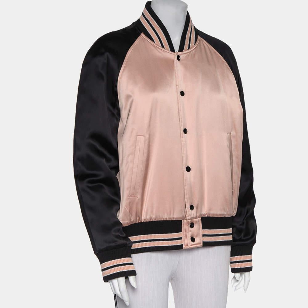 Complete a luxe look by wearing this charming bomber jacket by Saint Laurent. Designed to be a reliable style companion, the women's designer jacket is detailed with striped rib trims and two pockets. The long-sleeved creation is secured by front