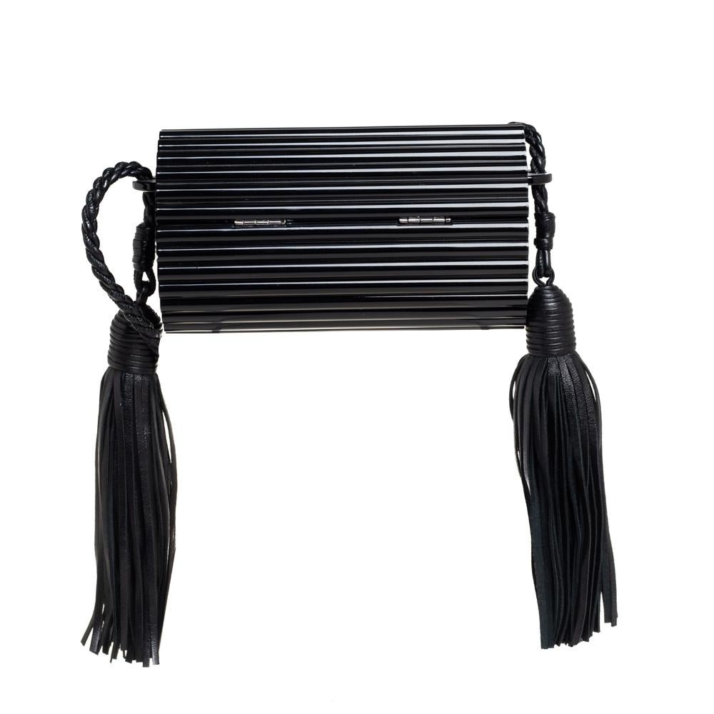 This Minaudière clutch by Saint Laurent Paris is utterly breathtaking! This clutch makes a loud fashion statement with every detail. It has a ribbed plexiglass exterior and a well-sized leather interior. The clutch is complete with a cord that has