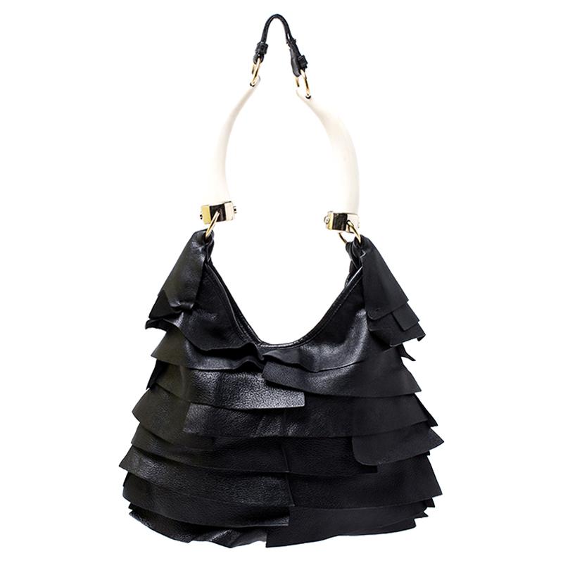 Show your elegant fashion sense by carrying this Saint Laurent Paris ‘St. Tropez’ horn hobo bag. Crafted of black leather with signature tiered ruffle panels, this bag features a single horn handle that is enhanced with gold-tone hardware. The