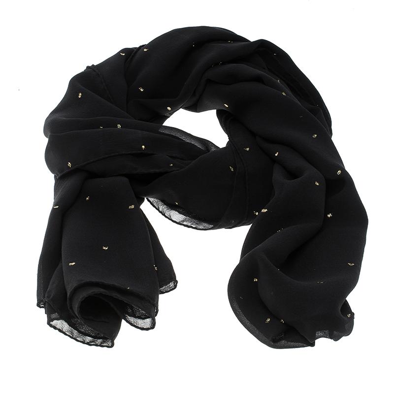 Cut from a luxurious black silk fabric, this Saint Laurent Paris stole is adorned with metallic dots all over and finished off with rounded edges. The versatile and classic black hue make it an easy accessory for any outfit. Wrap it loosely around