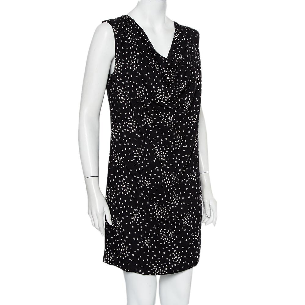 This black star-printed sleeveless dress by Saint Laurent is a casual statement piece that is sure to make heads turn. Made in twill, with a silver back zip, this shift dress will be an elegant and unique addition to your wardrobe. The star print