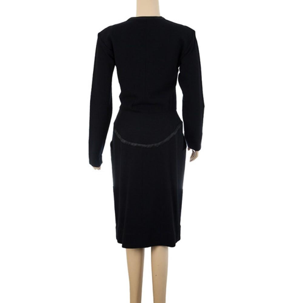 This stunning black Saint Laurent wrap dress features a deep V neckline and long sleeves. It has a below knee in-length and features three-quarter length sleeves. This dress has draped details and an asymmetric hem.

Includes: The Luxury Closet