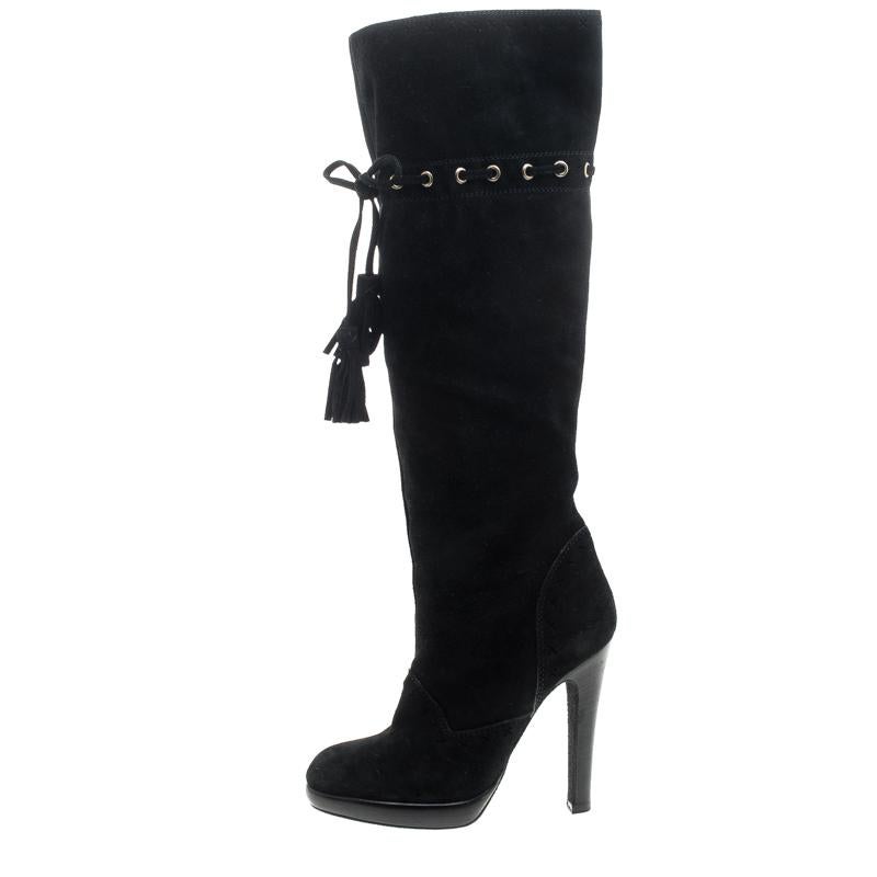 With these knee boots from Saint Laurent Paris, you'll be all set to look stylish and warm. Crafted from black suede, they feature strings laced through eyelets and left loose as tassels. They are finished with round toes and 12 cm heels.

