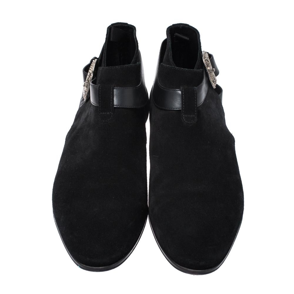 Fabulous and chic, these ankle booties from Saint Laurent Paris are sure to be an amazing addition to your collection! The black boots are crafted from suede and feature round toes. They flaunt a leather strap around the ankles detailed with