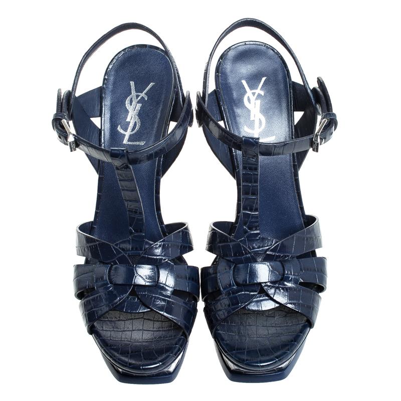 One of the most sought-after designs from Saint Laurent is their Tribute sandals. They are such a craze amongst fashionistas around the world, and it is time you own one yourself. These blue ones are designed with croc-embossed leather straps, ankle