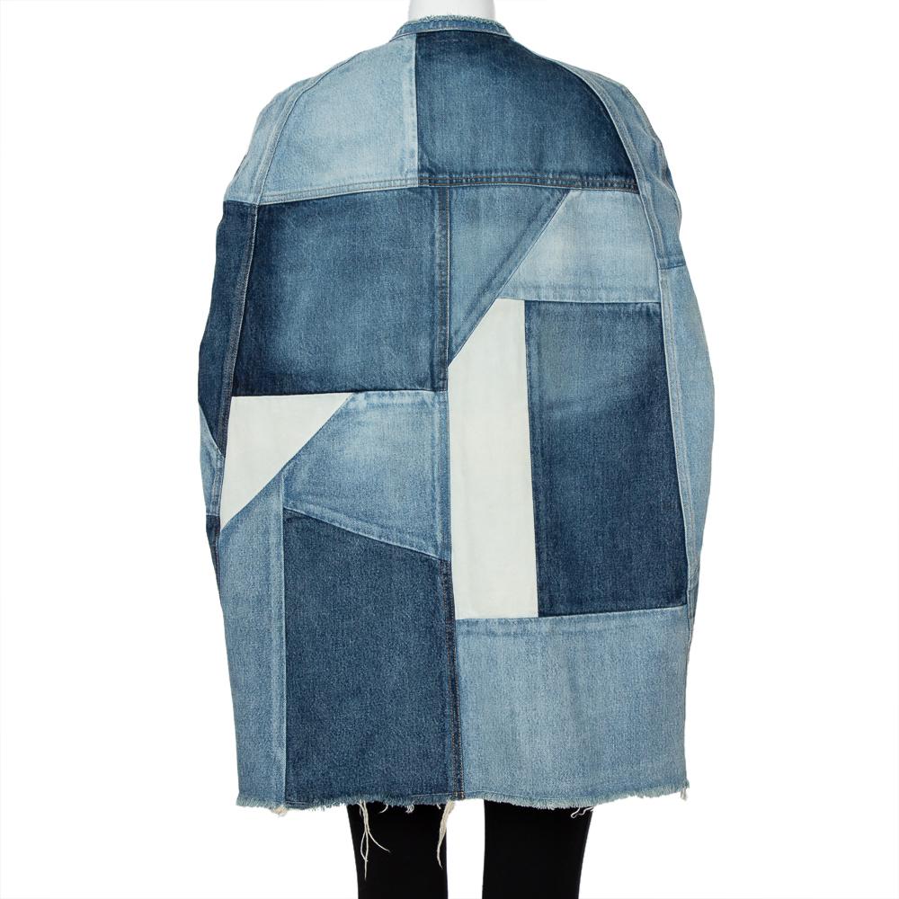 From Saint Laurent Paris' Spring/Summer 2016 ready-to-wear collection, this denim cape is chic, unique, and statement-making. It has an open front silhouette and is made from patches of denim and features slashed armholes.

