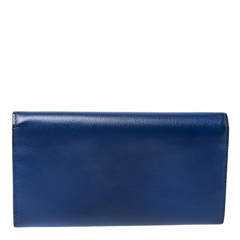 A suave creation from the house of Saint Laurent Paris. Featuring a leather exterior, this wallet is a convenient accessory with a zip pocket, multiple card slots and a full flap with a snap-button closure. The rich blue hue of this stylish wallet