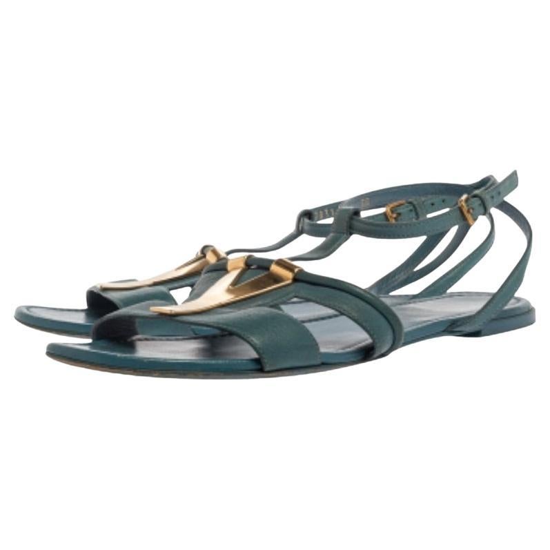 These flats from Saint Laurent Paris amalgamate comfort and style in equal proportions! They have been crafted from leather in a blue shade and designed with cut-out vamp straps that are detailed with the signature 'Y' motifs in gold-tone. They