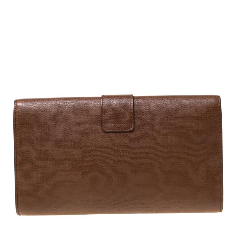 Classy and super stylish, this clutch is a Saint Laurent creation. It has been luxuriously crafted from brown leather and shaped to complement all your elegant outfits. The insides are lined with satin and sized to carry your necessities. The clutch