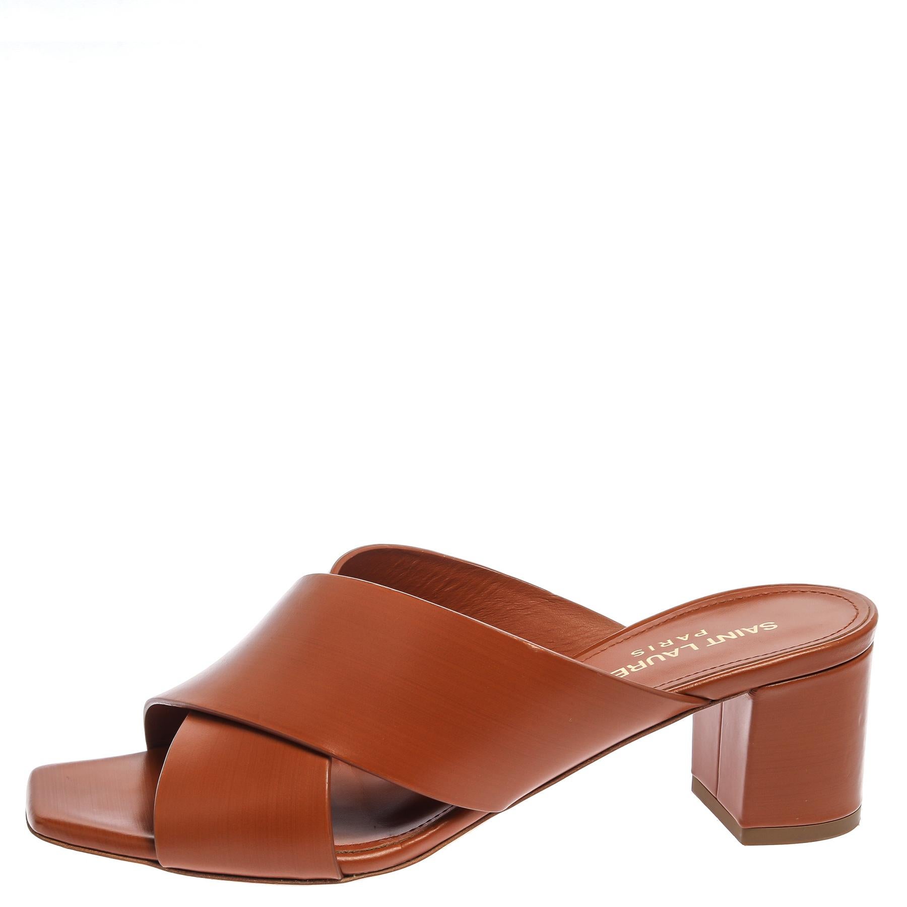 Charm your way to all your social gatherings in this pair of mules from Saint Laurent Paris. Crafted from brown leather, they carry a feminine design with criss-cross straps and beautiful block heels.

Includes: Original Dustbag, Original Box, Info