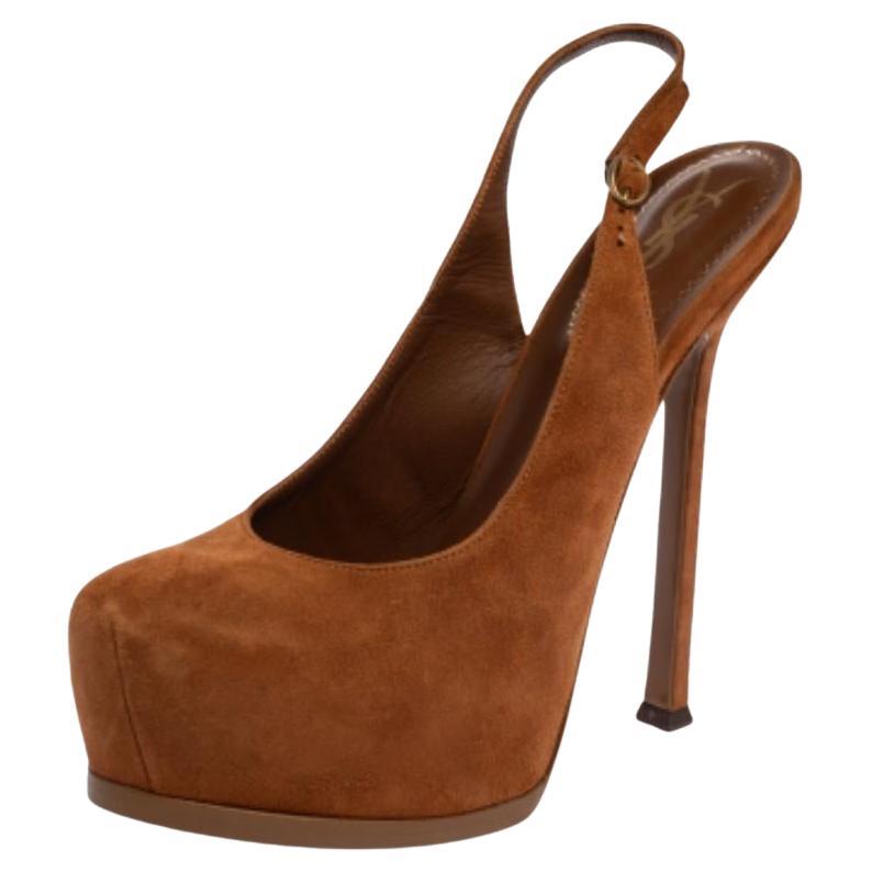 Fashionable and chic, these Tribtoo sandals from Saint Laurent will cut an alluring silhouette from day to night. Crafted from suede, the sandals have a brown shade, slingback straps, concealed platforms, and 14.5 CM heels.
