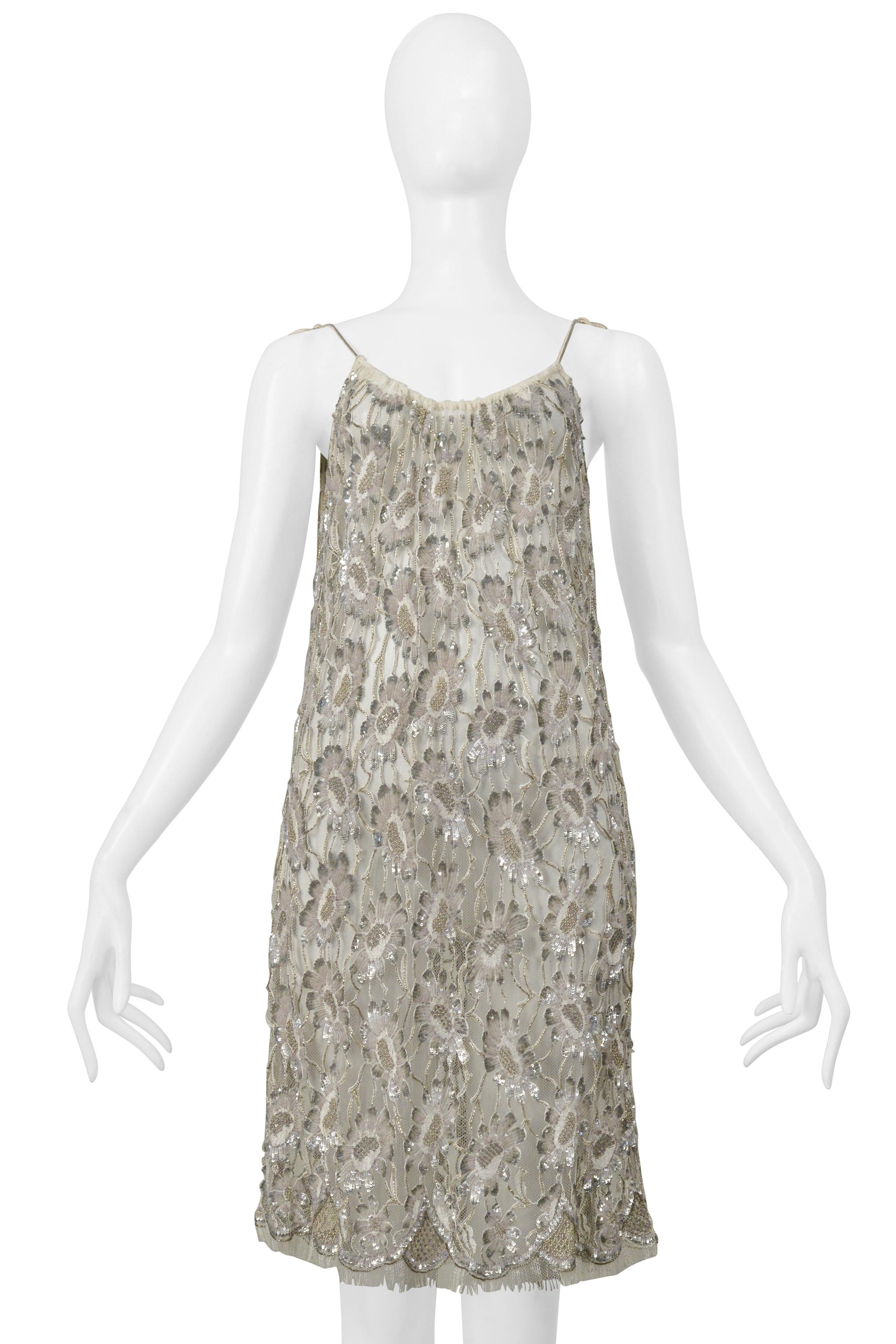 Resurrection is thrilled to present a stunning Saint Laurent Paris slip dress featuring delicate lace, silver beading, and skinny straps that tie and above-the-knee length. 

Saint Laurent Paris
Designed By Hedi Slimane 
Size No size label fits like