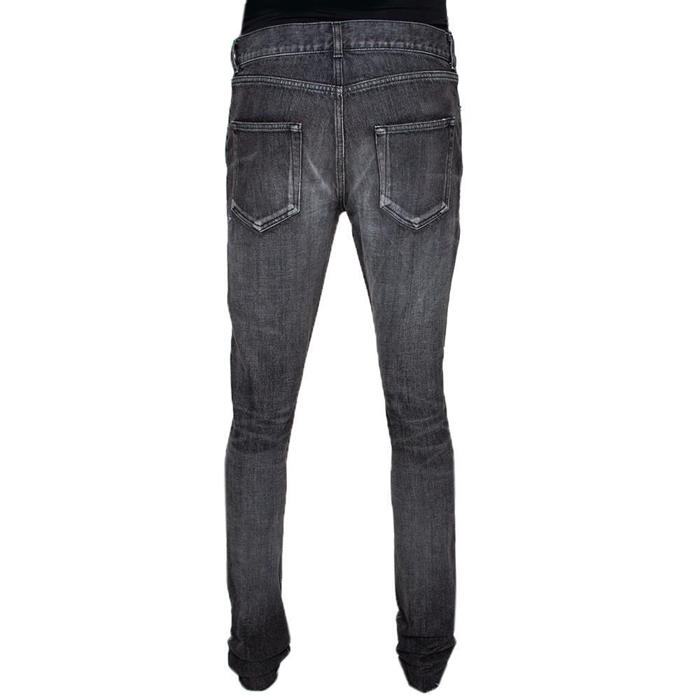 This pair of charcoal grey jeans from Saint Laurent is made from medium wash denim in a slim-fit cut and features raw edges. To highlight its design, you can balance it with T-shirts and sneakers or a leather jacket, a white shirt and boots.

