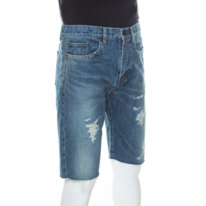 Denim Capri shorts have always been a style staple. These from Saint Laurent Paris come tailored from 100% cotton and designed with five pockets and zip-button closure. Detailed with belt loops, the shorts are finished with distressed accents on the