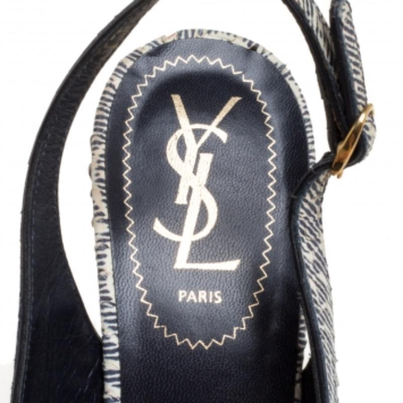 Fashionable and chic, these Tribtoo sandals from Saint Laurent will cut an alluring silhouette from day to night. Crafted from cream and black printed python-embossed leather, the sandals flaunt slingbacks, concealed platforms, and 15 cm high heels.