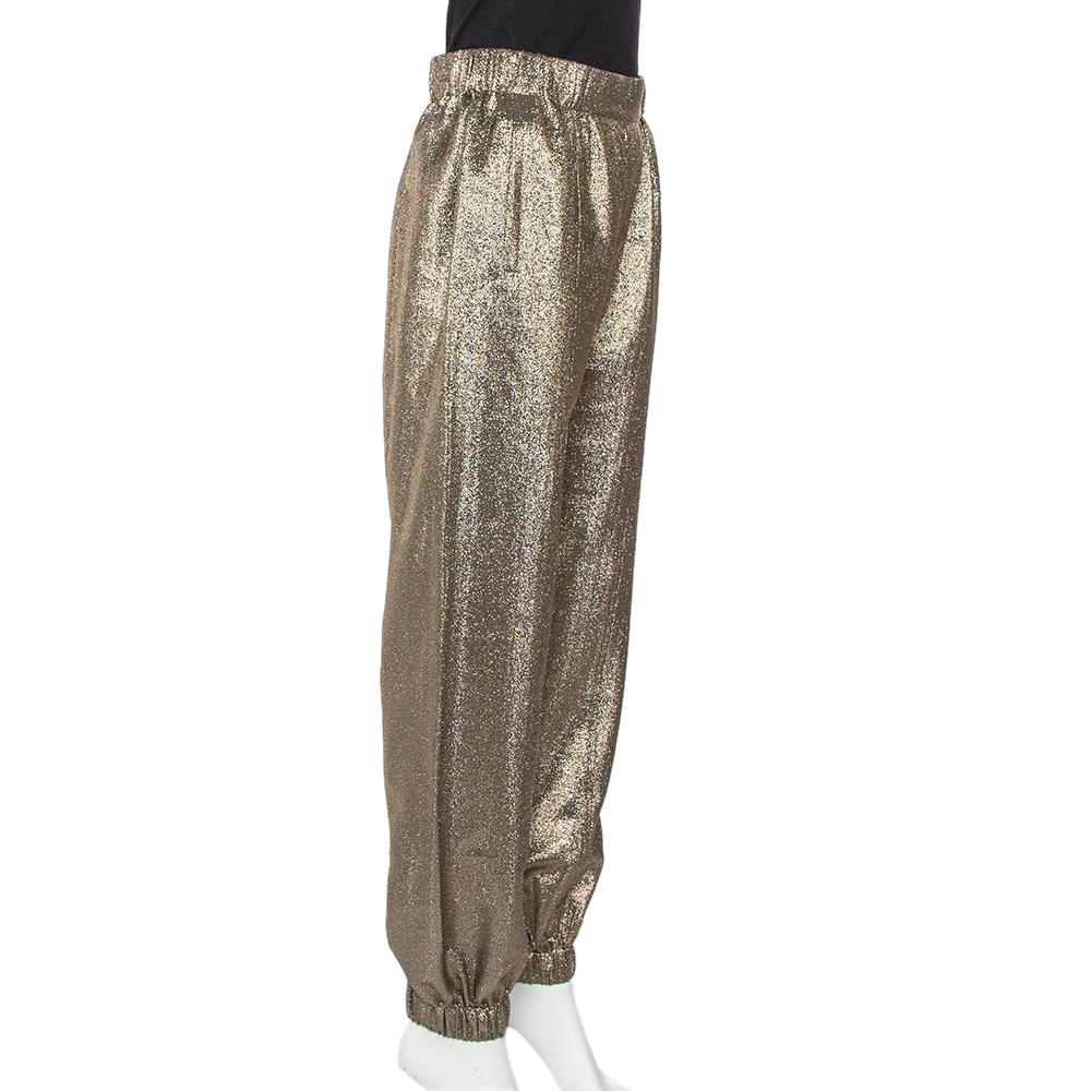 These immaculately crafted Saint Laurent joggers embody the label's chic attitude. These gold pants are crafted from lurex silk and feature an elastic waist, two pockets, and cuffs on the hem.

