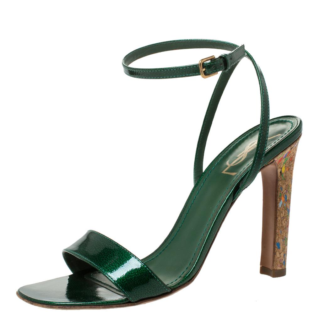Effortlessly stylish and playful, these sandals by Saint Laurent Paris will elevate any outfit instantly. Crafted from glossy patent leather, they carry a brilliant shade of green. They are styled with open toes, buckled ankle straps, gold-tone