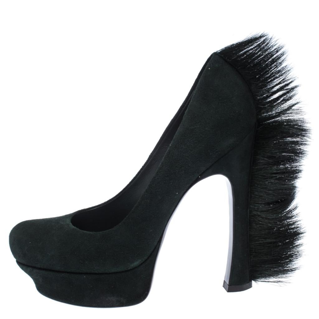 The most-wanted pair of shoes from Saint Laurent's Fall 2010 collection, can now become yours! These sleek green Mohawk pumps are crafted from smooth suede and are finished with statement-making 14 CM heels with fur trims, platforms, and rounded