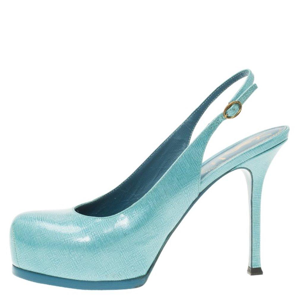 Mesmerize the world with these Light Blue Patent Tribtoo Slingbacks by Saint Laurent Paris. Crafted from textured leather, these round-toed, slingback sandals stand tall on the Tribute’s signature square heels. The self-covered platforms are coupled