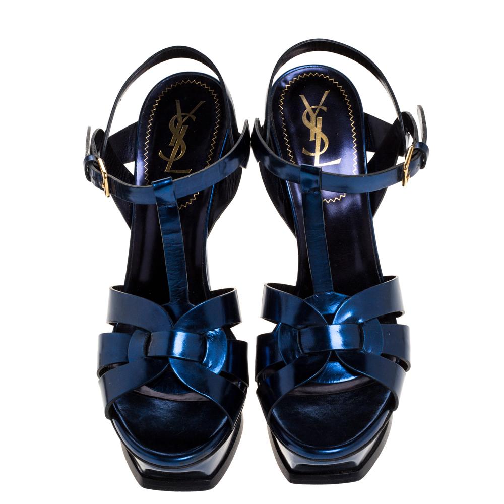 One of the most sought-after designs from Saint Laurent is their Tribute sandals. They are such a craze amongst fashionistas around the world, and it is time you own one yourself. These metallic dark blue ones are designed with leather straps, ankle