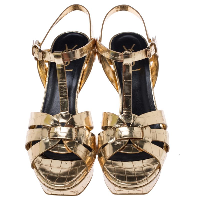 One of the most sought-after designs from Saint Laurent is their Tribute sandals. They are such a craze amongst fashionistas around the world, and it is time you own one yourself. These metallic gold ones are designed with croc-embossed leather