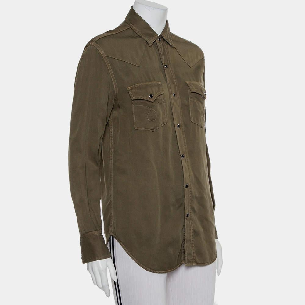 Perfect to pair with a simple pair of jeans or tucked into a smart skirt, Saint Laurent's shirt is an easy-to-stye item. It is designed in military green with a simple collar, long cuffed sleeves, chest pockets, and front button closure.

