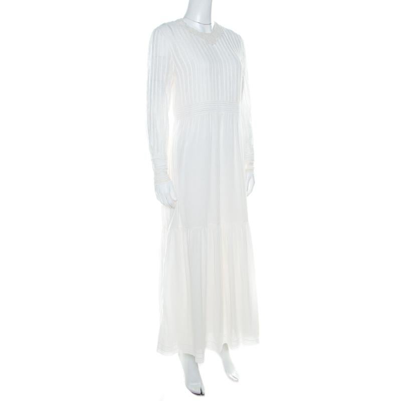 Stand out from the crowd with this pretty and understated piece from the house of Saint Laurent Paris. Kick-start your weekend on a unique note with this opulent off-white dress designed in a tiered silhouette with lace-ups in the front. Tailored