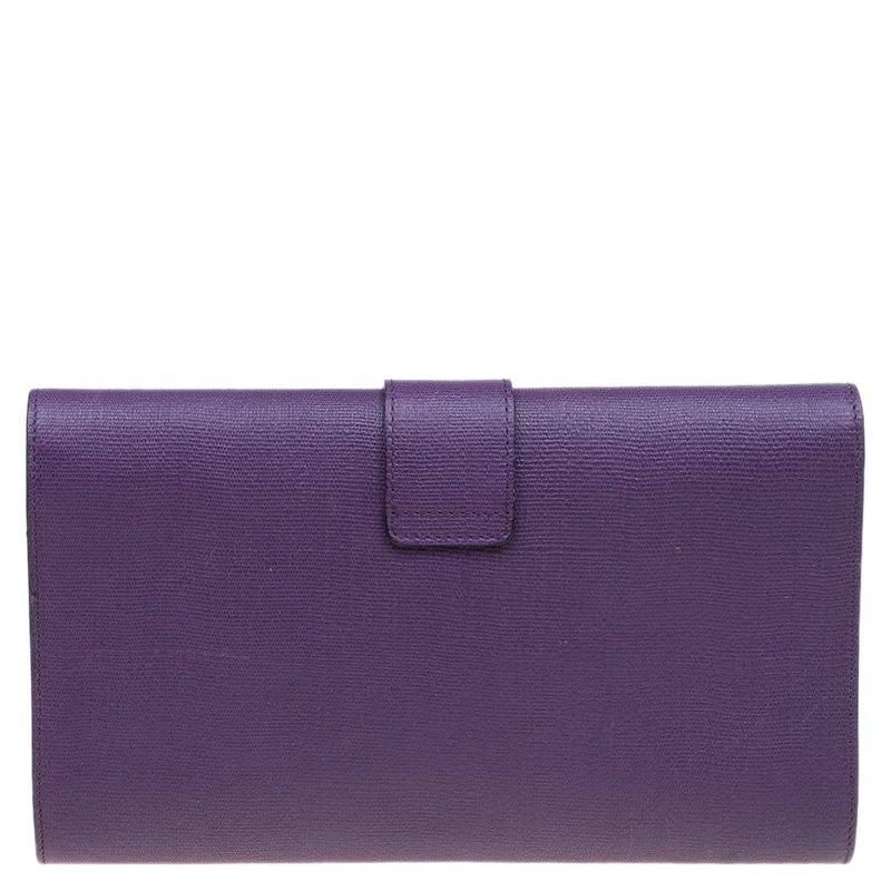 Made of textured leather in a peppy purple, this clutch is all you need to shine in your evening outfit. The envelope structured clutch opens to a sleek stain lined pocket with an inner flat pocket and comes with a magnetic snap button closure. A