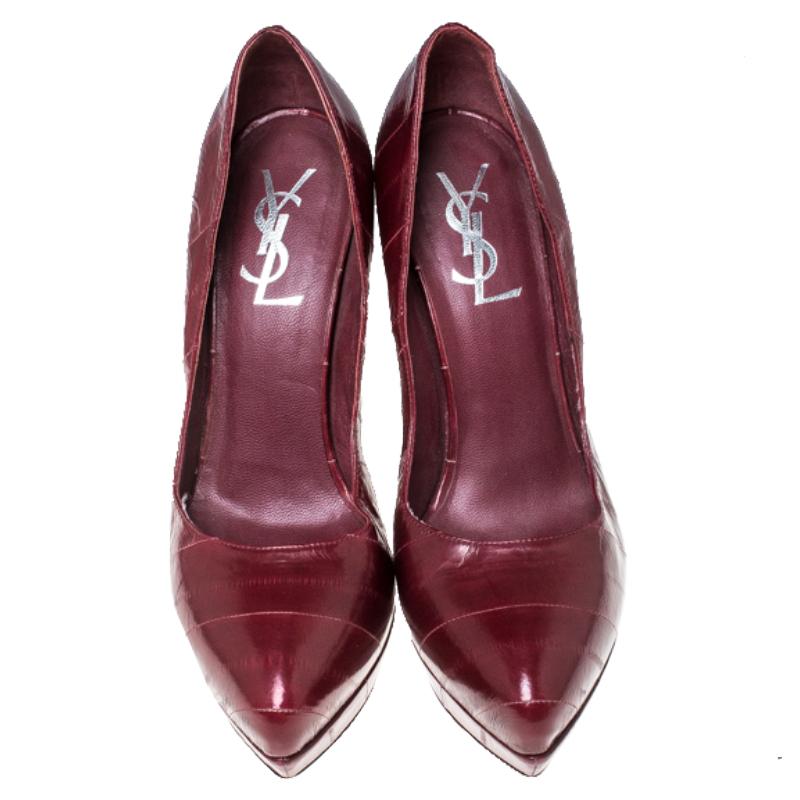 Mysterious and sensuous, these Saint Laurent Paris pumps are divine just like their name. Their burgundy embossed leather exterior is coupled with almond toes, curved self-covered soles, and 10.5cm heels. They are lined with red leather and feature