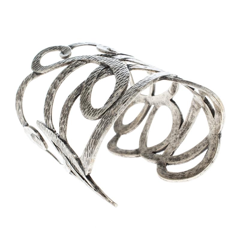 Every once in a while you need to outshine everyone else and make a lasting impression! This open cuff bracelet from Saint Laurent Paris helps you do that with its striking beauty and sophisticated appeal. It is crafted from silver-tone metal and