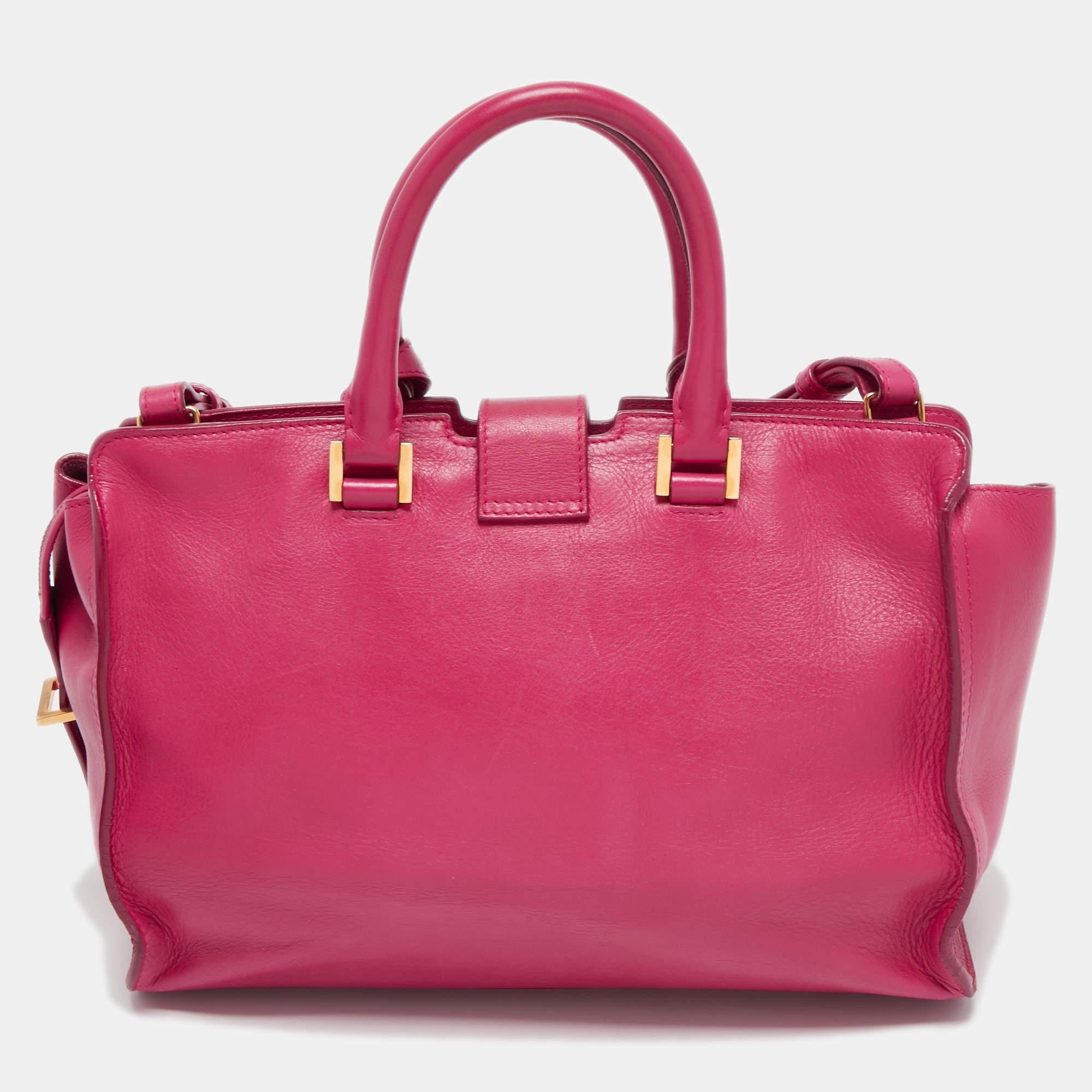 This elegant Pink Cabas Chyc tote from Saint Laurent is ideal for everyday use. Crafted from leather, the bag is detailed with a hold tone hardware Y motif snap closure, and dual rolled handles. The top zip closure opens to a spacious interior that