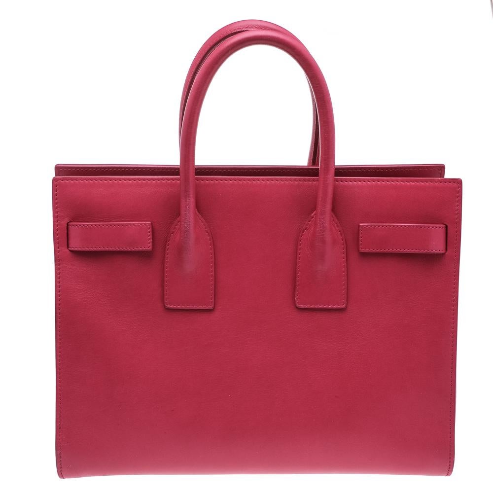 Made in a sweet pink shade, this Saint Laurent Sac De Jour tote has a refined look. It comes made from leather and is lined with suede. The different handles, zipper closure, and spacious interior enhance the design. Complete with a lock and key