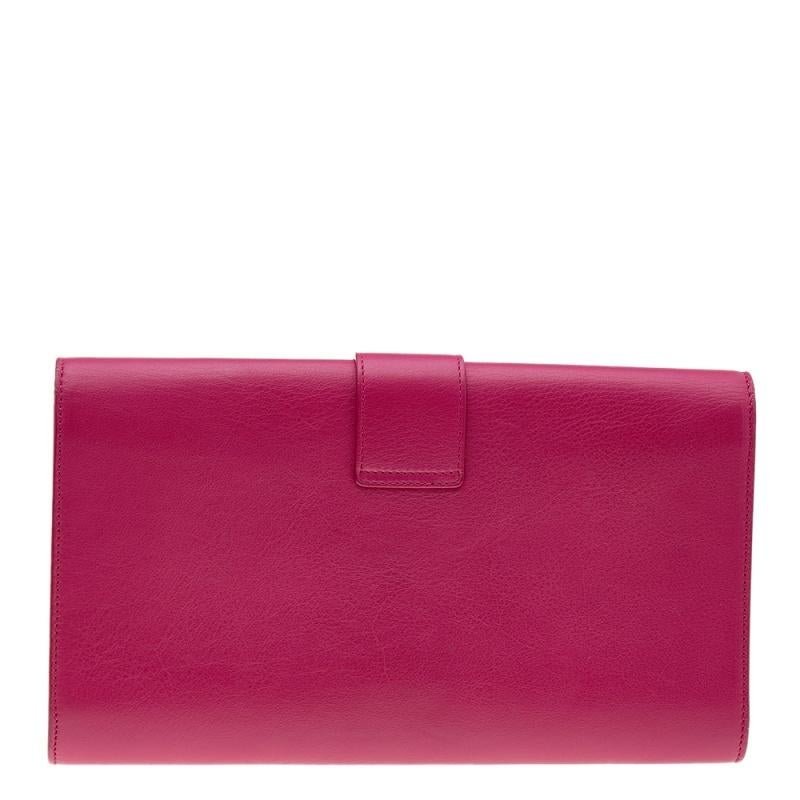 Designed in a gorgeous pink-hued leather body, this Saint Laurent clutch features a flap style and is detailed with the iconic 'Y' logo. It has tonal stitching and it opens to reveal several card slots inside the pink interior.

Includes: Original