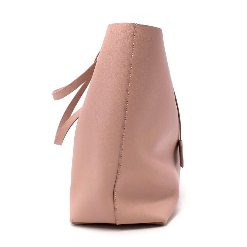 Pink Saint Laurent Shopper Leather Tote Bag
 

 -A supple blush pink, textured calfskin leather 
 -Two top handles 
 -A spacious unlined interior for a lightweight feel
 -A snap-fastening tab at the open top
 -Gold-Tone stamped logo 
 -A removable