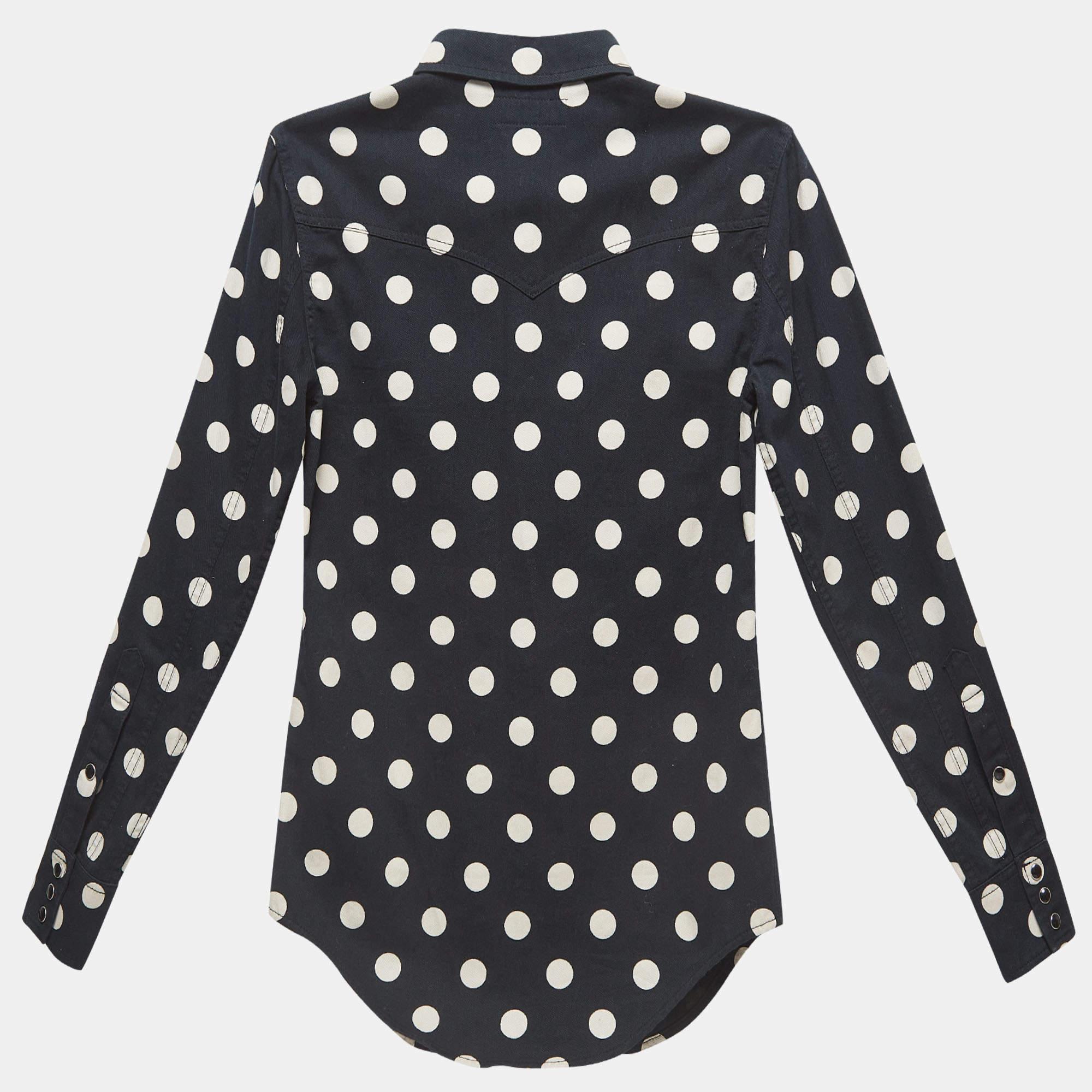 Step into elegance with the Saint Laurent shirt. Crafted from premium cotton, its slim cut exudes sophistication. Adorned with playful polka dots, this piece effortlessly blends classic charm with contemporary style, making it a versatile essential