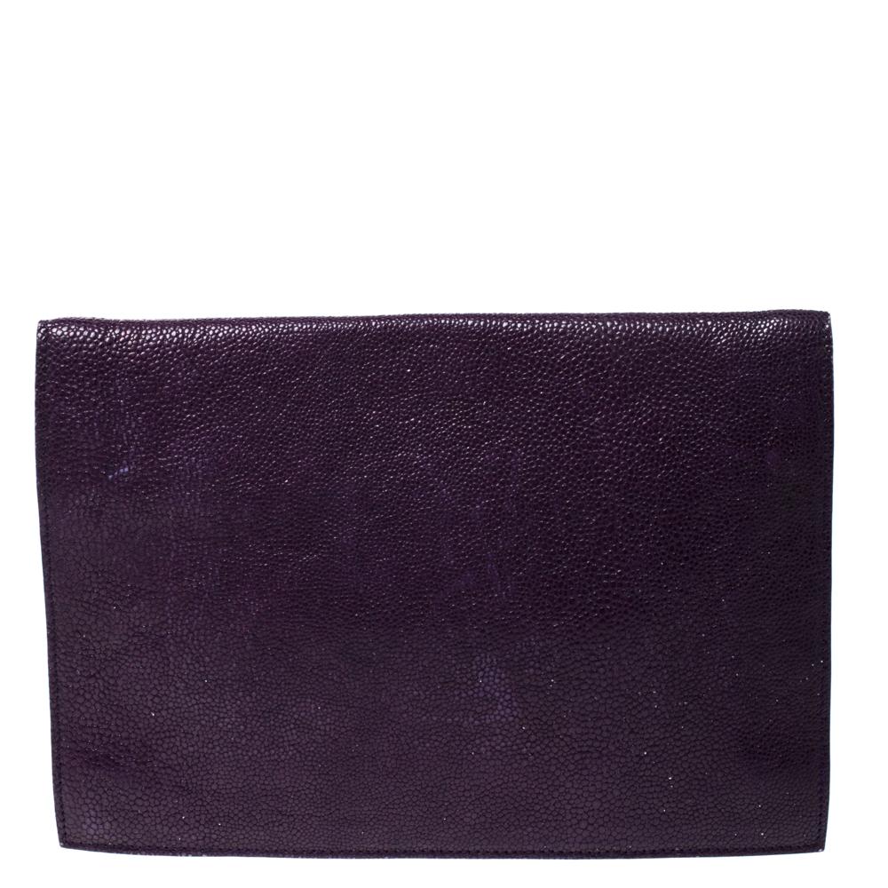 Well known for their exquisiteness and leading designs, Saint Laurent creations are at the top of every fashionista's list. Presenting in a lovely shade of purple, this envelope clutch has a front flap with Y-shaped pocket closure that opens to a