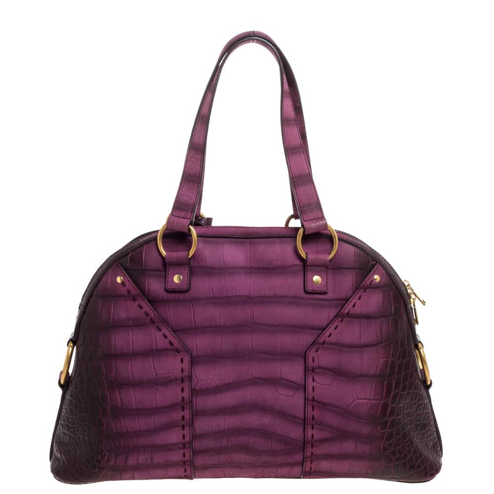This Saint Laurent Muse satchel is perfect for everyday use. Crafted from purple ombre croc-embossed nubuck leather, this satchel has two handles attached with gold-tone rings and a dangling clochette. The zip closure opens to a roomy satin-lined