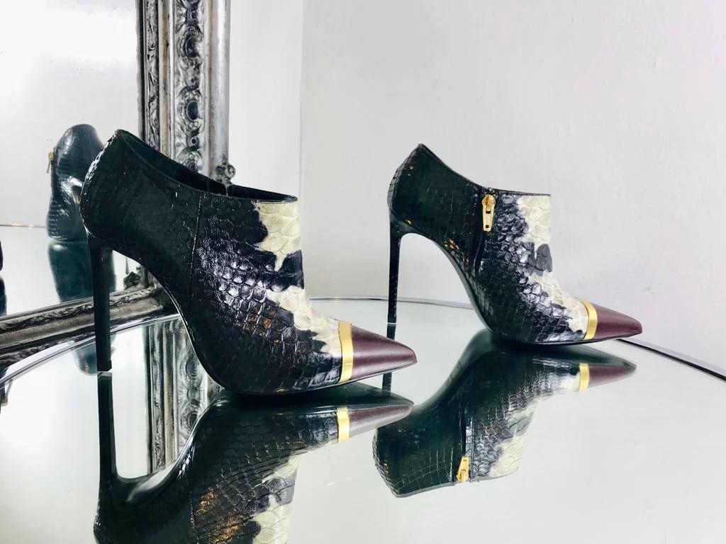 Never Worn Saint Laurent Ankle Shoe/Boots

Black and white Python skin,  with brown leather and a gold detail to the front

Additional information:
Size – 37.5
Composition - Snake Skin, Leather
Condition – Brand New 
Comes with- Boots Only