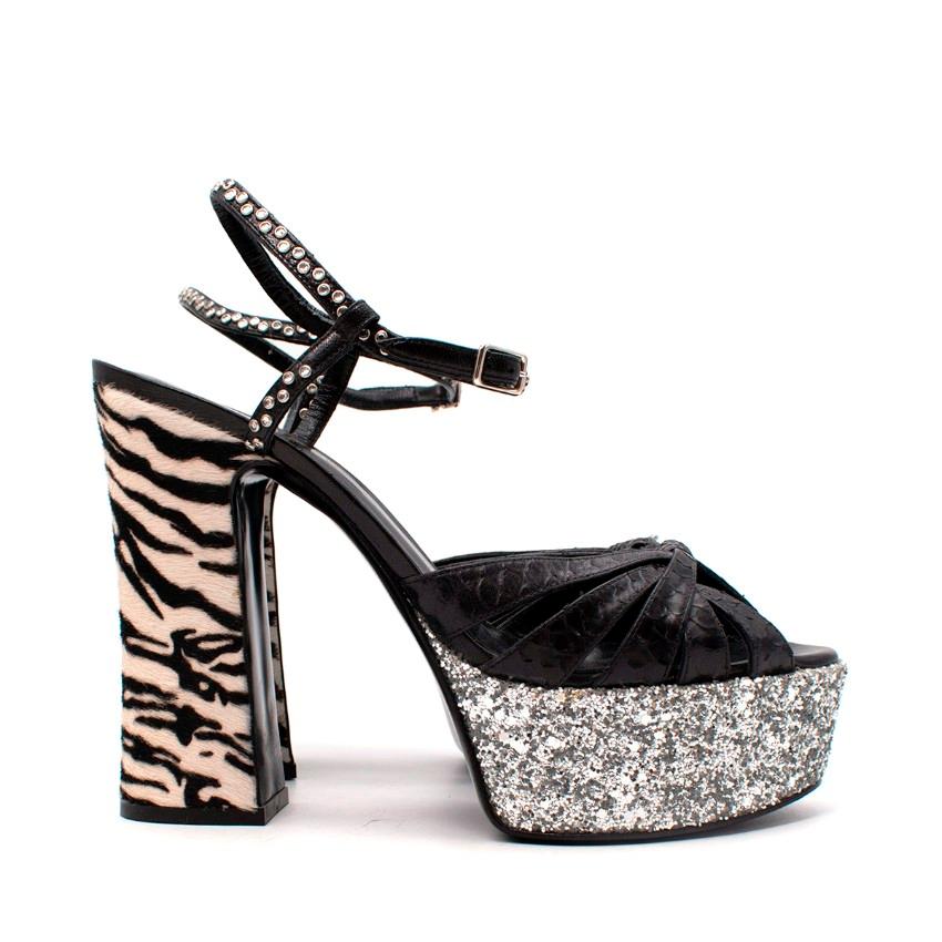 Saint Laurent Python, Glitter & Ponyskin Platform Sandals
 

 - Iconic candy platform sandal rendered in an unusual, edgy combination of materials
 - A glitter encrusted platform is contrasted with a zebra print ponyskin heel, whilst the foot strap