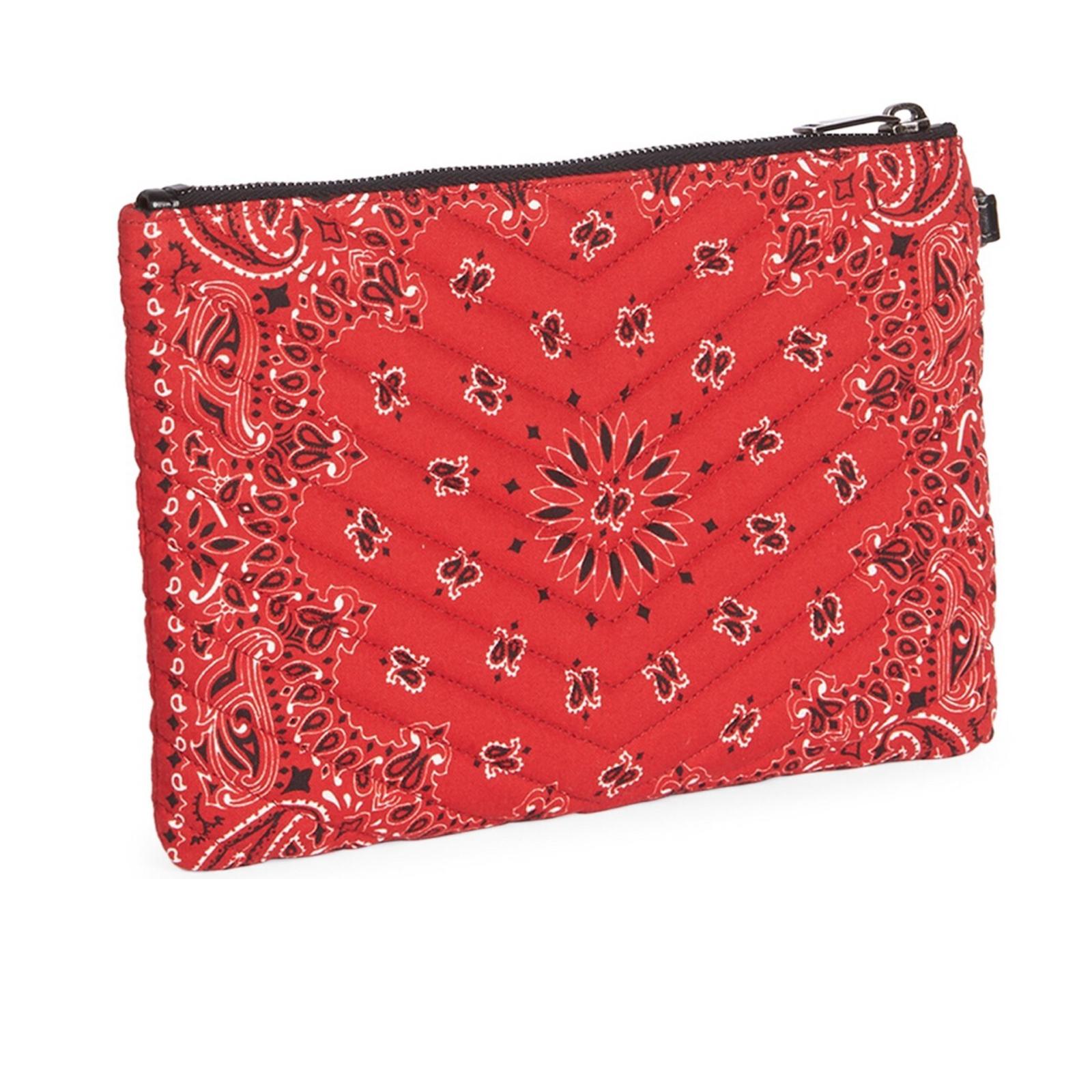 This pouch bag is made with red fabric with a paisley bandana print in black and white. The pouch features a polished aged silver YSL monogram logo at the front, an attachable black leather wristlet strap, top zip closure and an interior with black