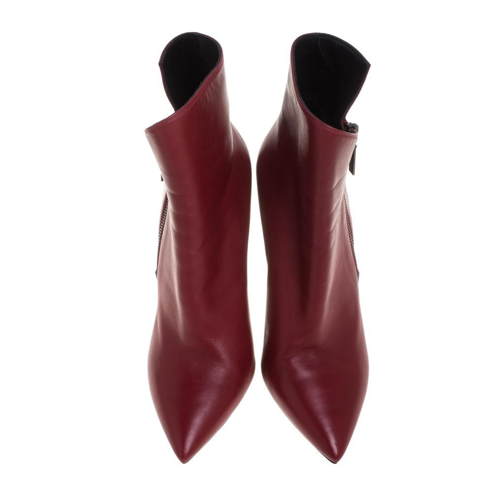 Add a bold and smart feel to your outfit with these boots from Saint Laurent. These ankle boots are made from red leather featuring a unique design of pointed toes and conical heels. The insoles are lined with leather and feature the brand labels