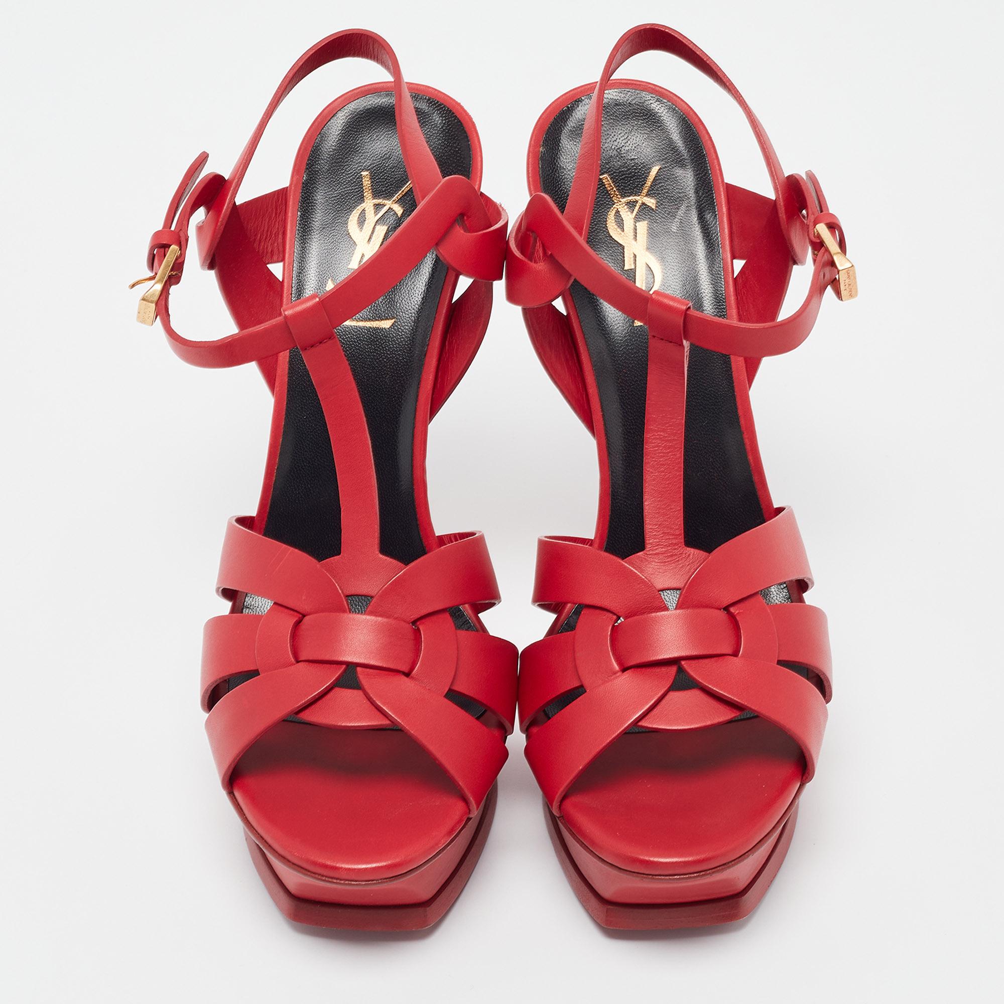 A timeless aesthetic and stellar craftsmanship in shoemaking are evident in these Saint Laurent platform sandals. From their interwoven construction using leather to the sturdy heels supported by platforms, these red-hued Tribute sandals can be