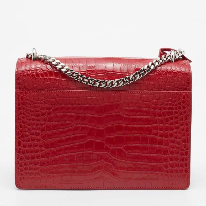 Fall in love with this Sunset bag from Saint Laurent! Crafted from shiny croc-embossed leather, it flaunts the 'YSL' logo on the front flap in silver-tone metal. It has a spacious, plush suede-lined interior that houses pockets. This black beauty is