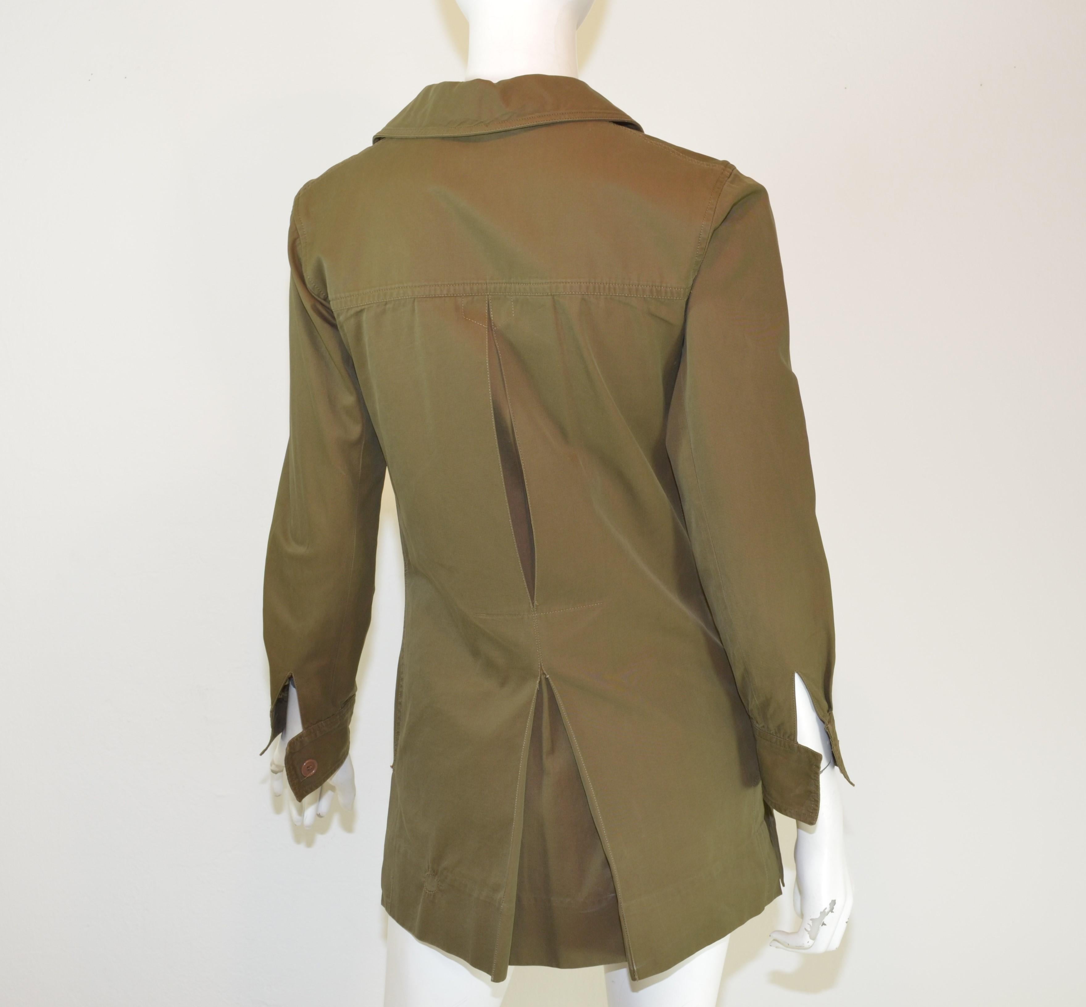 This Yves Saint Laurent vintage safari jacket was gifted to a Parisian model in 1969 and it is featured in an olive green cotton twill with a lace up tie fastening and four functional patch pockets. Jacket has button placements along the cuffs of