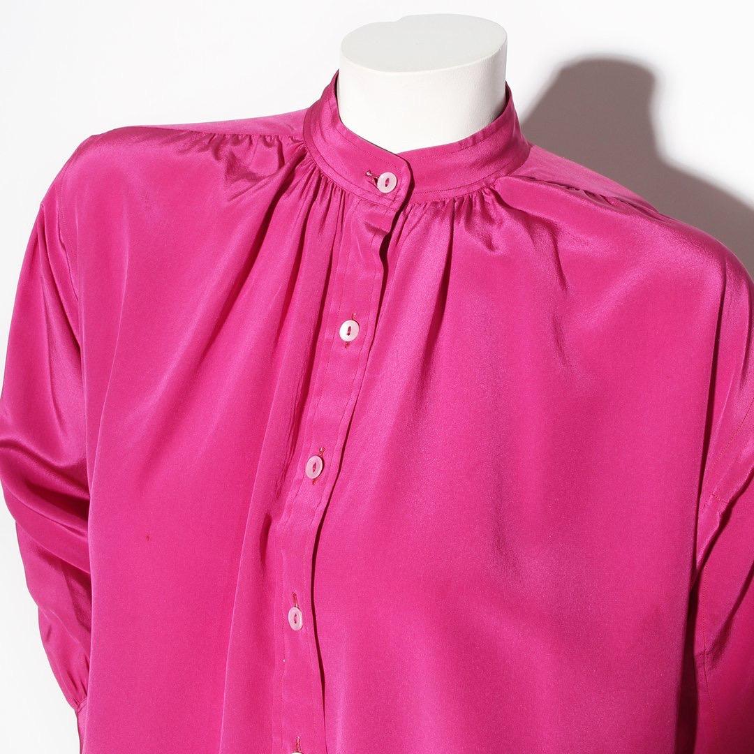Saint Laurent Rive Gauche Designer Blouse 
Made in France
Vintage 
Circa 1980's 
Fuchsia 
100% Silk 
Mandarin collar 
Button-Up 
Two buttons at cuffs of sleeve 
Very good vintage condition; Preloved and vintage age with a very small discoloration on
