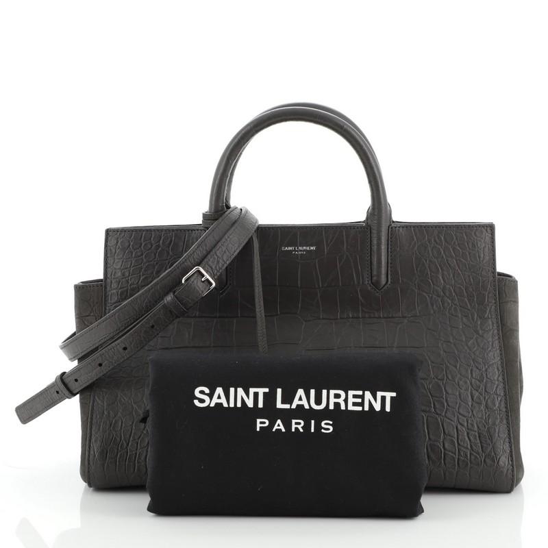 Condition: Excellent. Slight wear on exterior and in interior, scratches on hardware. 
Accessories: Luggage Tag, Dust Bag, With Strap 
Measurements: 
Designer: Saint Laurent
Model: Rive Gauche Cabas Crocodile Embossed Leather Small
Exterior