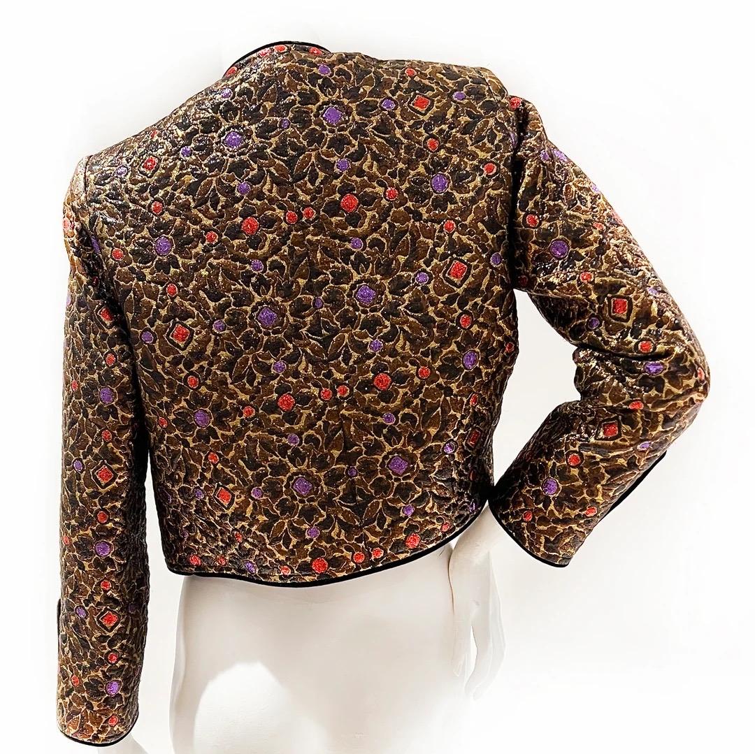 Saint Laurent Rive Gauche Evening Jacket 
Fall / Winter 1984 
Vintage 
Made in France 
Crop style jacket
Lurex floral pattern brocade 
Brown brocade with highlights of purple and red 
Gold sunburst buttons with red crystals 
Three button detail at