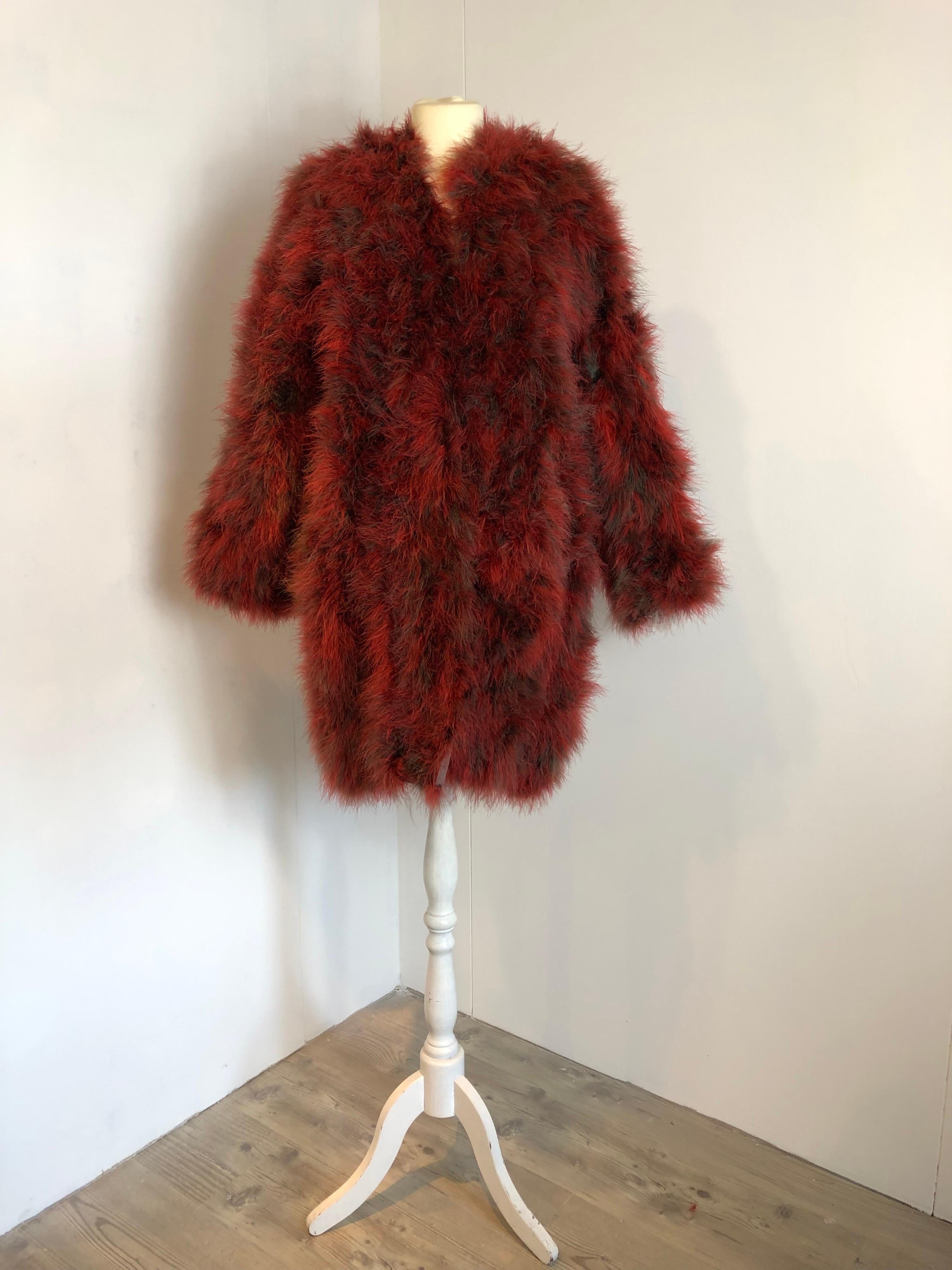 Saint Laurent , Rive Gauche fur. About 70s/80s.
100% feathers, lining 100% acetate. 
Featuring 2 frontal pockets and clips closure. 
Size 40 FR.
Measurements:
Shoulders 44 cm
Bust 54 cm
Sleeves 62 cm
Length 94 cm 
Condition: Good - Previously owned